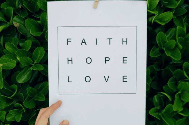 Person holding a paper-Faith, hope, love