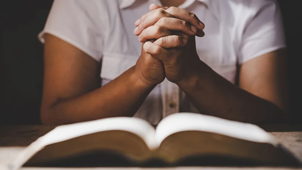A man writing his prayers for others